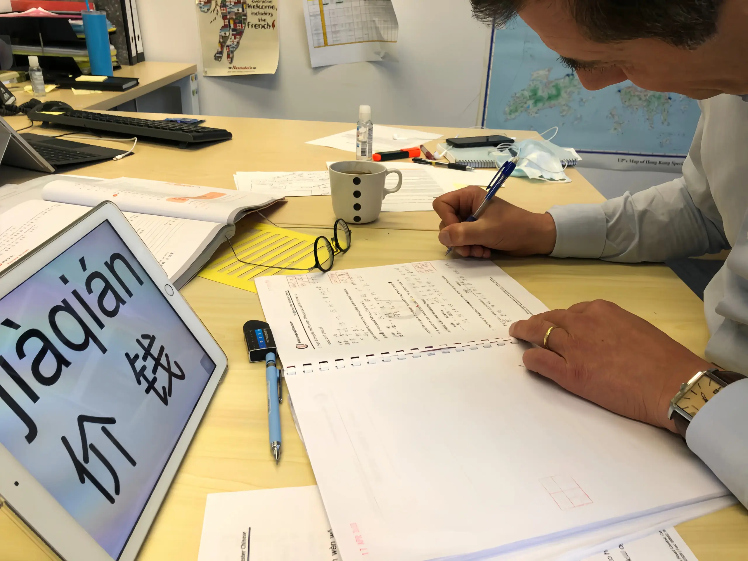 Student handwritten Chinese character practice, pinyin annotation, and professional teacher correction in Nihao Language Education's Mandarin class in Hong Kong