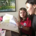 HKIS international school student reviewing customized Mandarin learning materials with a native teacher at Nihao Language Education Hong Kong.
