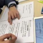 Expat corporate executive practicing customized Mandarin reading coursework and grammar notes at Nihao Language Education in Central Hong Kong.